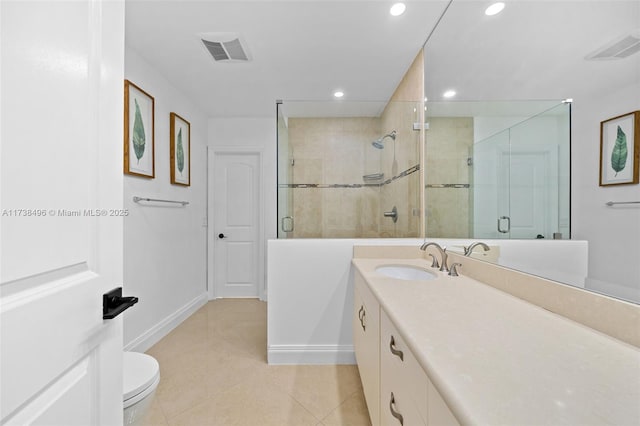 bathroom with tile patterned flooring, vanity, a shower with door, and toilet