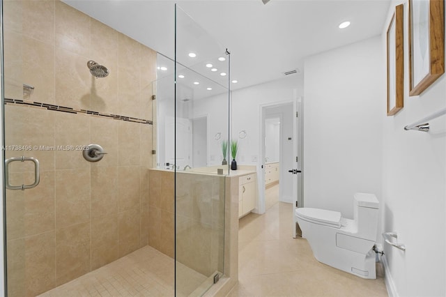 bathroom featuring an enclosed shower, vanity, tile patterned floors, and toilet