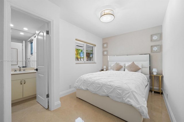 tiled bedroom with sink and connected bathroom