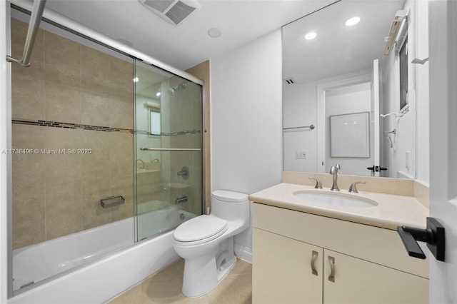 full bathroom with bath / shower combo with glass door, vanity, and toilet