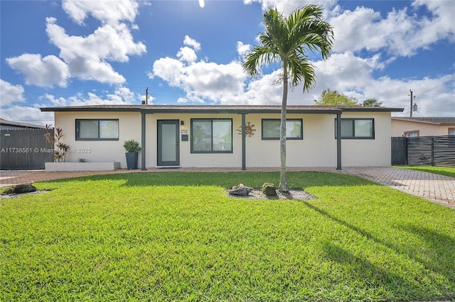 ranch-style home with fence, a front yard, and stucco siding