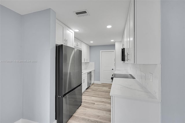 kitchen featuring white cabinets, light wood-style flooring, stainless steel appliances, recessed lighting, and visible vents