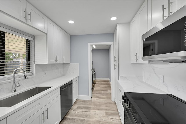 kitchen featuring a sink, white cabinets, stainless steel microwave, electric stove, and dishwashing machine