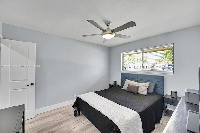 bedroom with baseboards, light wood-style flooring, and ceiling fan
