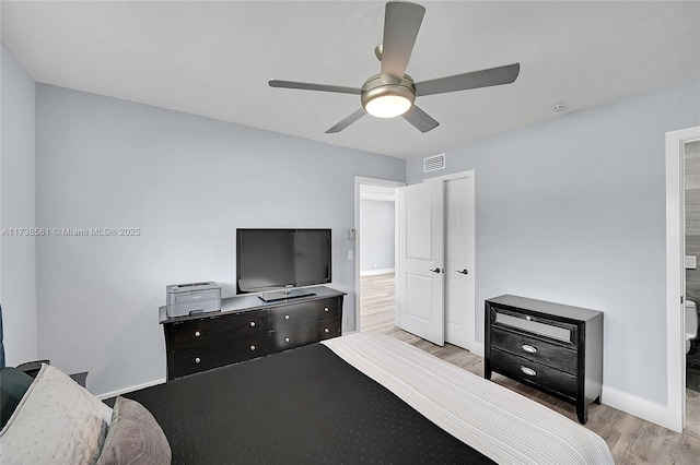 bedroom featuring visible vents, a ceiling fan, baseboards, and light wood-type flooring