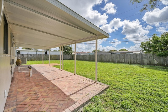 view of yard with central AC, a fenced backyard, and a patio area