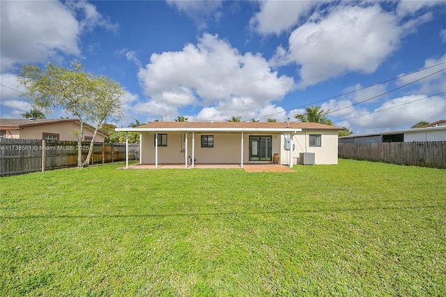 rear view of house featuring a fenced backyard, a patio, a lawn, and central AC unit