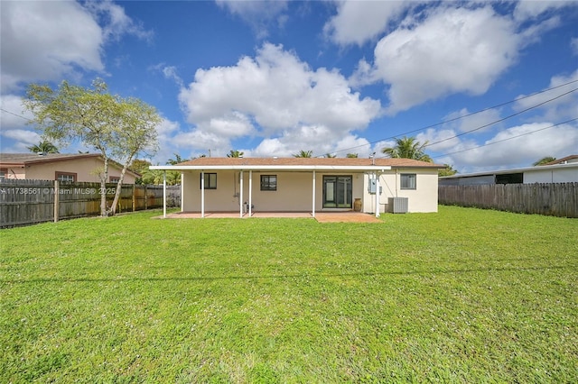 rear view of property with cooling unit, a lawn, and a patio area