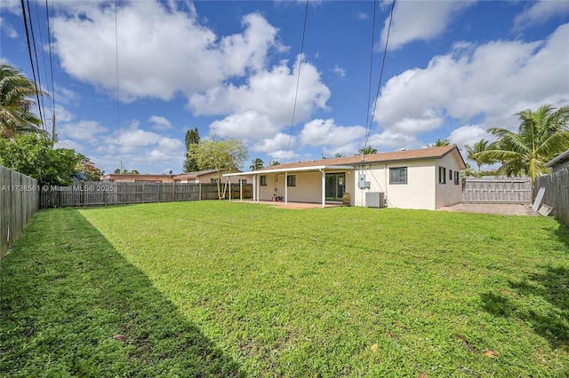 back of property featuring cooling unit, a yard, and a patio