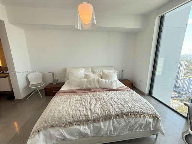 bedroom featuring wood-type flooring and access to exterior