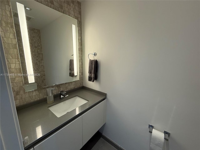 bathroom with vanity and decorative backsplash