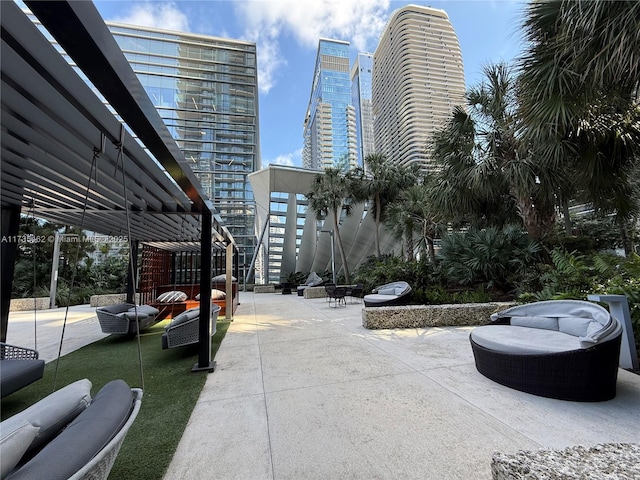 view of community with outdoor lounge area, a patio area, and a pergola