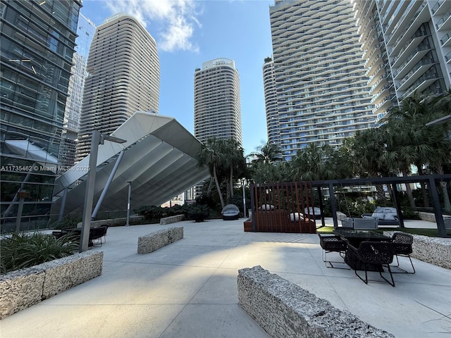 view of community with an outdoor hangout area and a patio