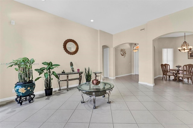 interior space featuring light tile patterned flooring and a notable chandelier