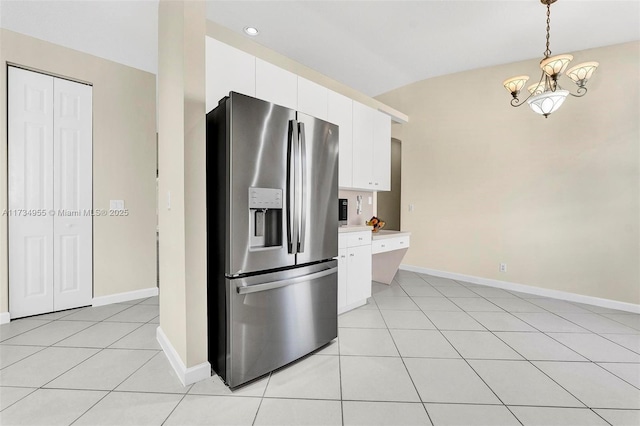 kitchen with light tile patterned flooring, white cabinetry, lofted ceiling, hanging light fixtures, and stainless steel refrigerator with ice dispenser