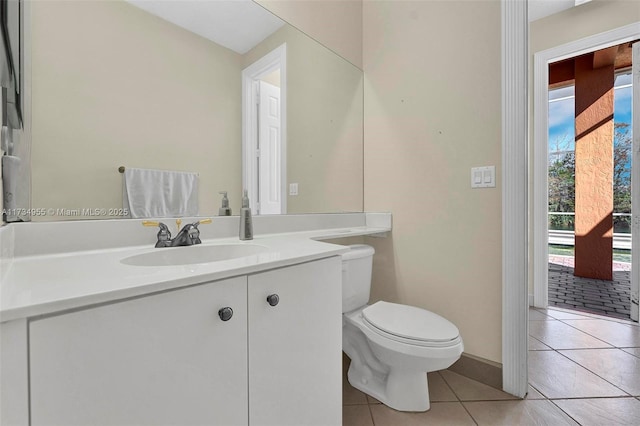 bathroom with vanity, toilet, and tile patterned flooring