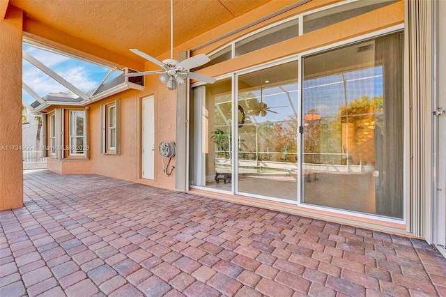 view of patio / terrace with a lanai and ceiling fan