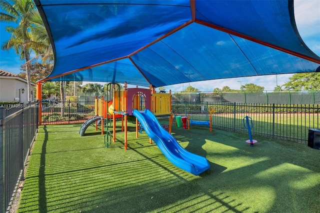 view of playground with a lawn