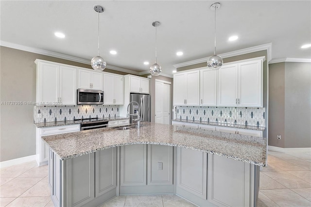 kitchen with white cabinetry, appliances with stainless steel finishes, decorative light fixtures, and a large island