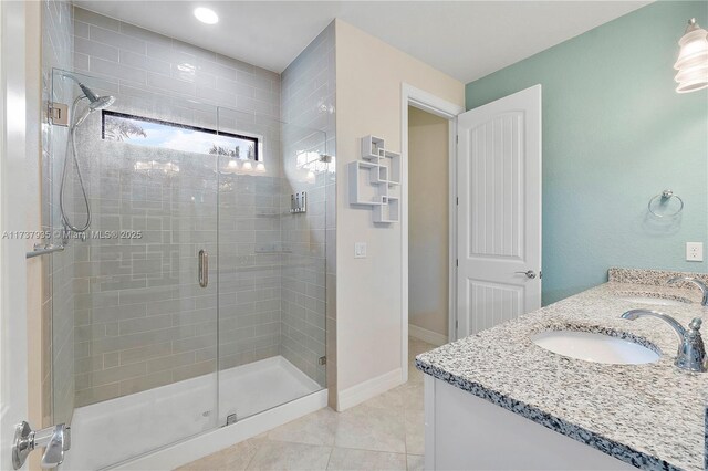 bathroom with tile patterned flooring, an enclosed shower, and vanity