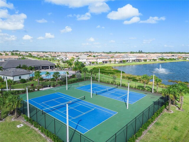 view of basketball court with a yard, tennis court, and a water view