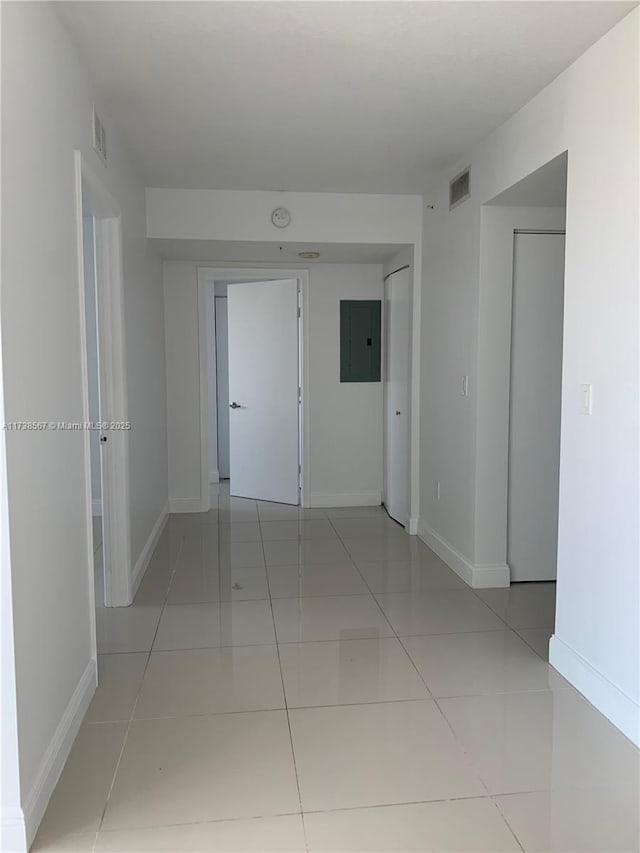 hall featuring electric panel and light tile patterned floors