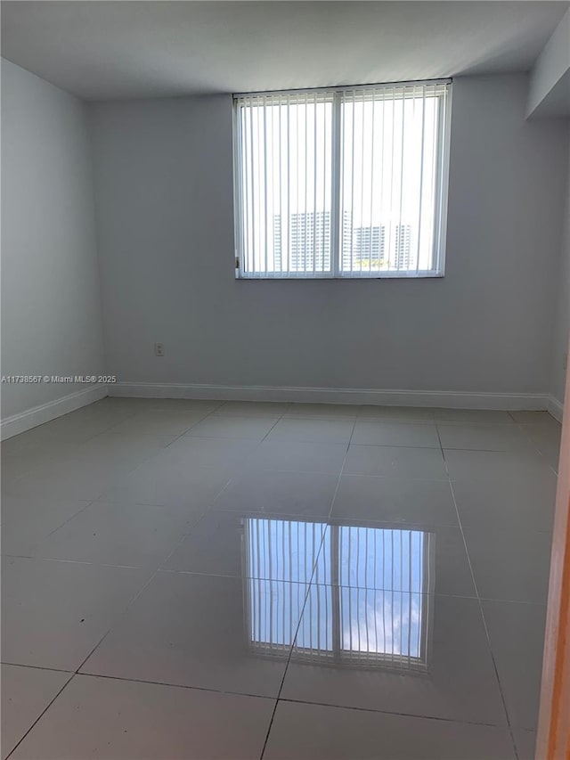 unfurnished room with tile patterned flooring