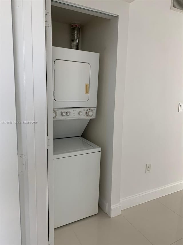 washroom with stacked washer and dryer