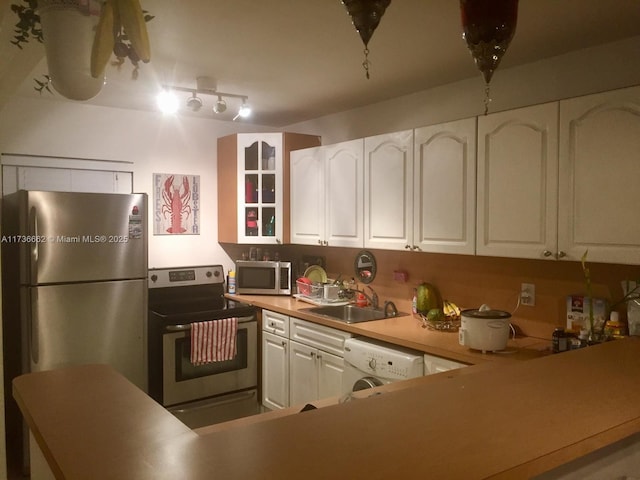 kitchen with washer / clothes dryer, sink, white cabinets, and appliances with stainless steel finishes