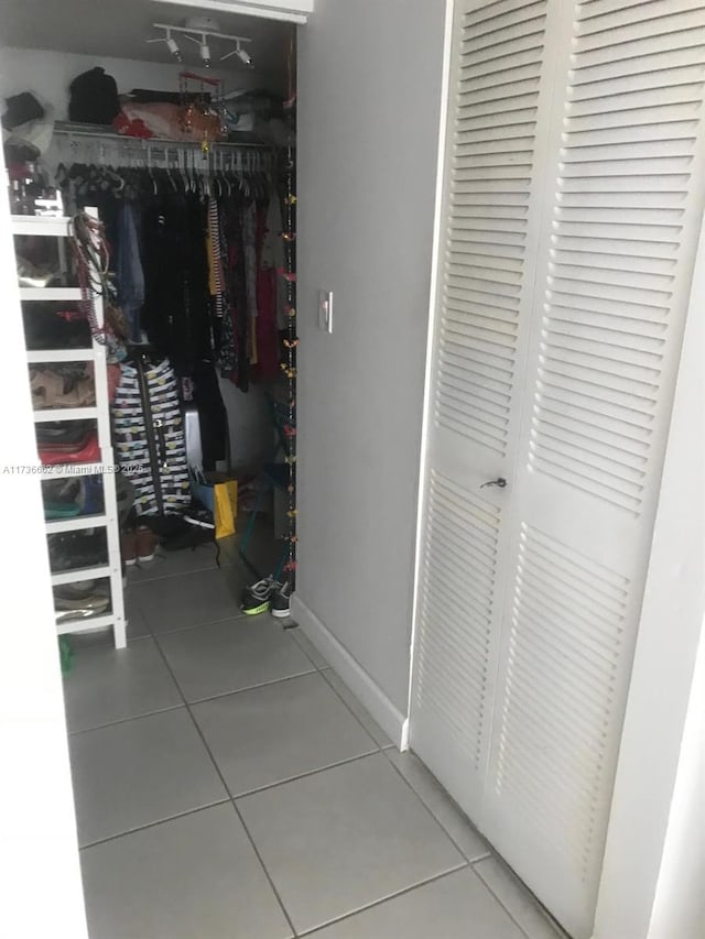 spacious closet with tile patterned floors