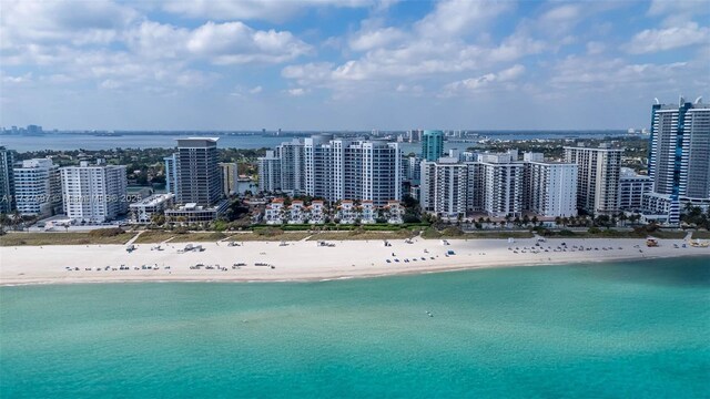 drone / aerial view with a beach view and a water view