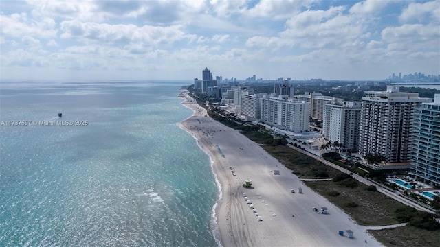 birds eye view of property featuring a water view and a view of the beach