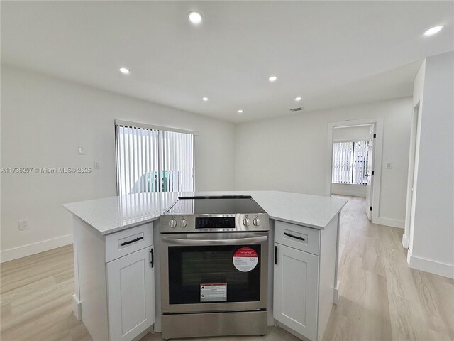 kitchen featuring white cabinetry, sink, hanging light fixtures, kitchen peninsula, and stainless steel appliances