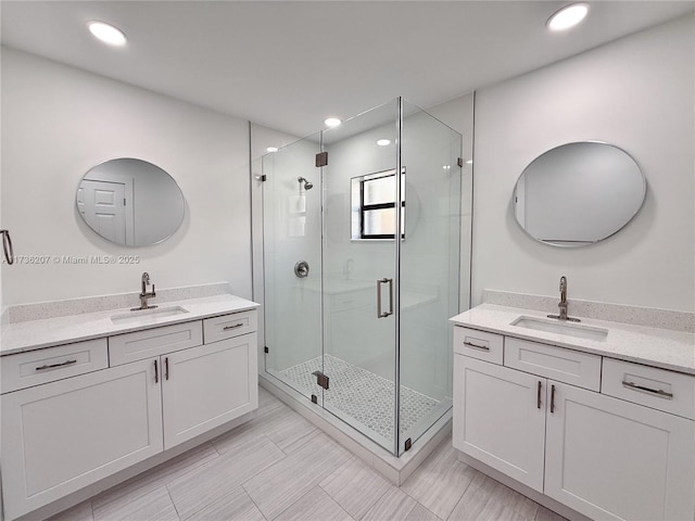 bathroom with vanity and a shower with door