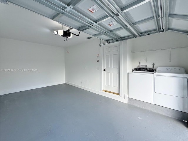 garage featuring separate washer and dryer and a garage door opener