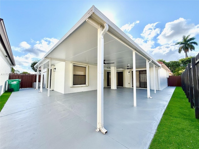 rear view of house with ceiling fan and a patio area