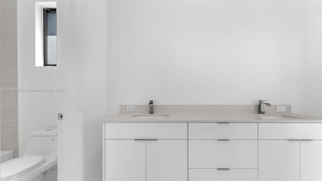 bathroom with vanity and toilet