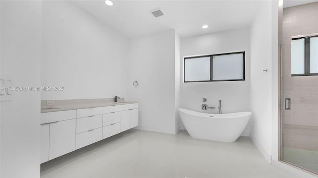 bathroom with vanity and shower with separate bathtub