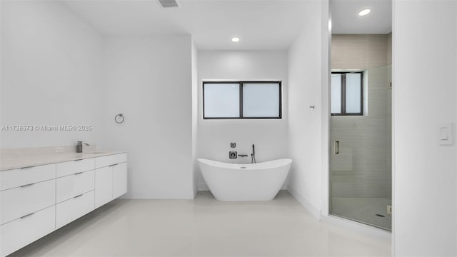 bathroom featuring vanity and shower with separate bathtub