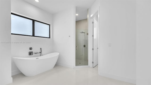 bathroom with separate shower and tub