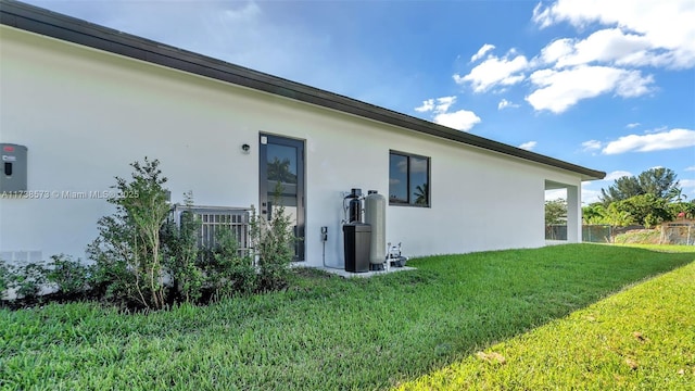 rear view of property featuring a yard