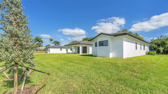 back of property featuring a lawn