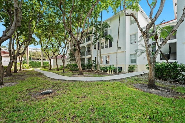 view of home's community featuring a lawn