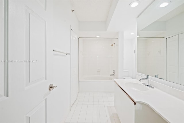 bathroom featuring tile patterned flooring, vanity, and tiled shower / bath