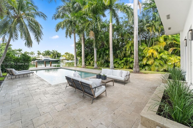 view of swimming pool featuring a water view, outdoor lounge area, and a patio area