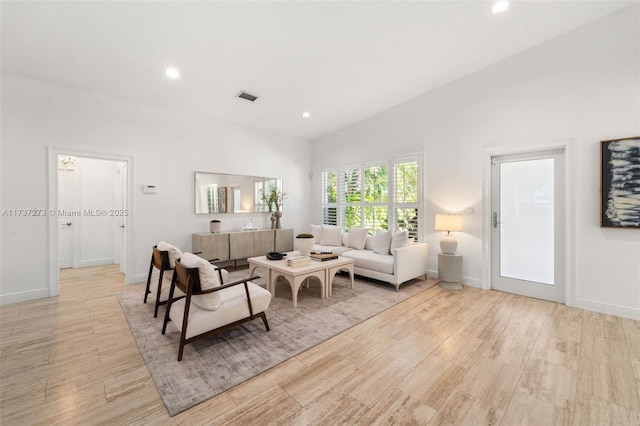 living room with lofted ceiling and light hardwood / wood-style floors