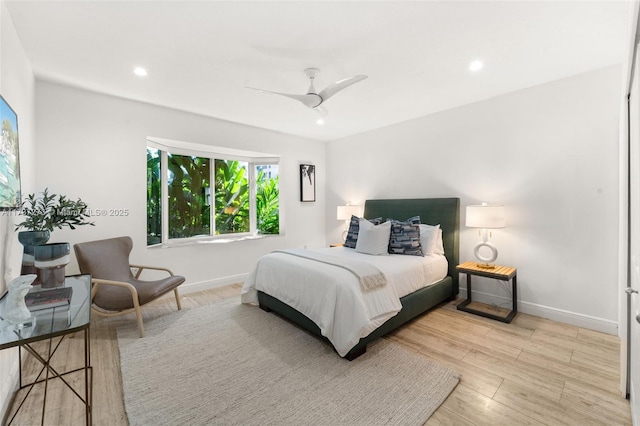 bedroom with ceiling fan and light hardwood / wood-style floors