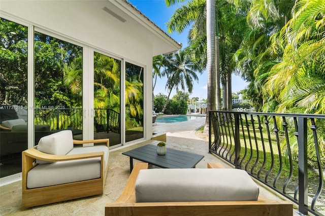 exterior space with a fenced in pool and a balcony