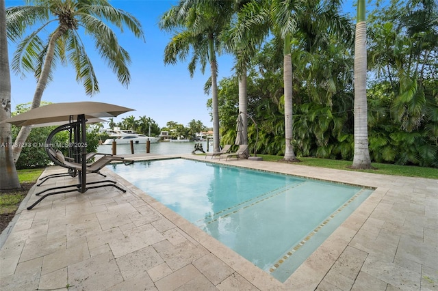 view of pool featuring a water view and a patio area