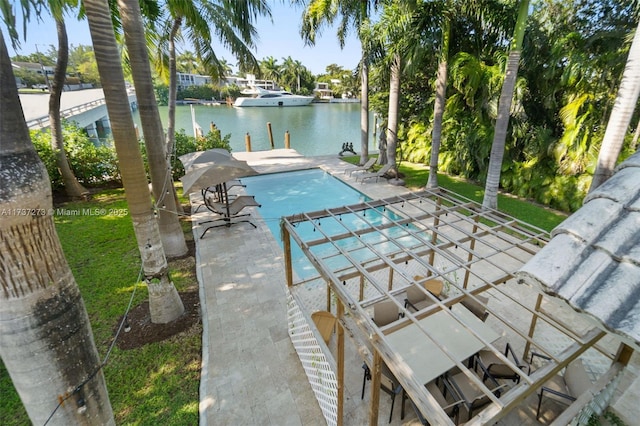 view of swimming pool featuring a patio and a water view